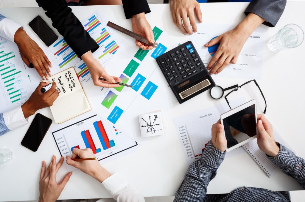 businessmen-hands-white-table-with-documents-drafts